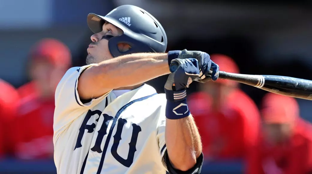 joshswingingthrowbacksfiu Baseball player swinging bat during game.